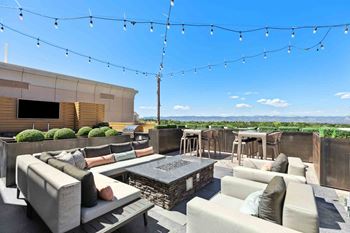 an outdoor patio with couches and a firepit